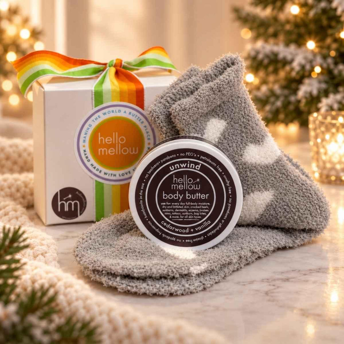 unwind 2 oz body butter and cozy sock gift wrapped in holiday setting