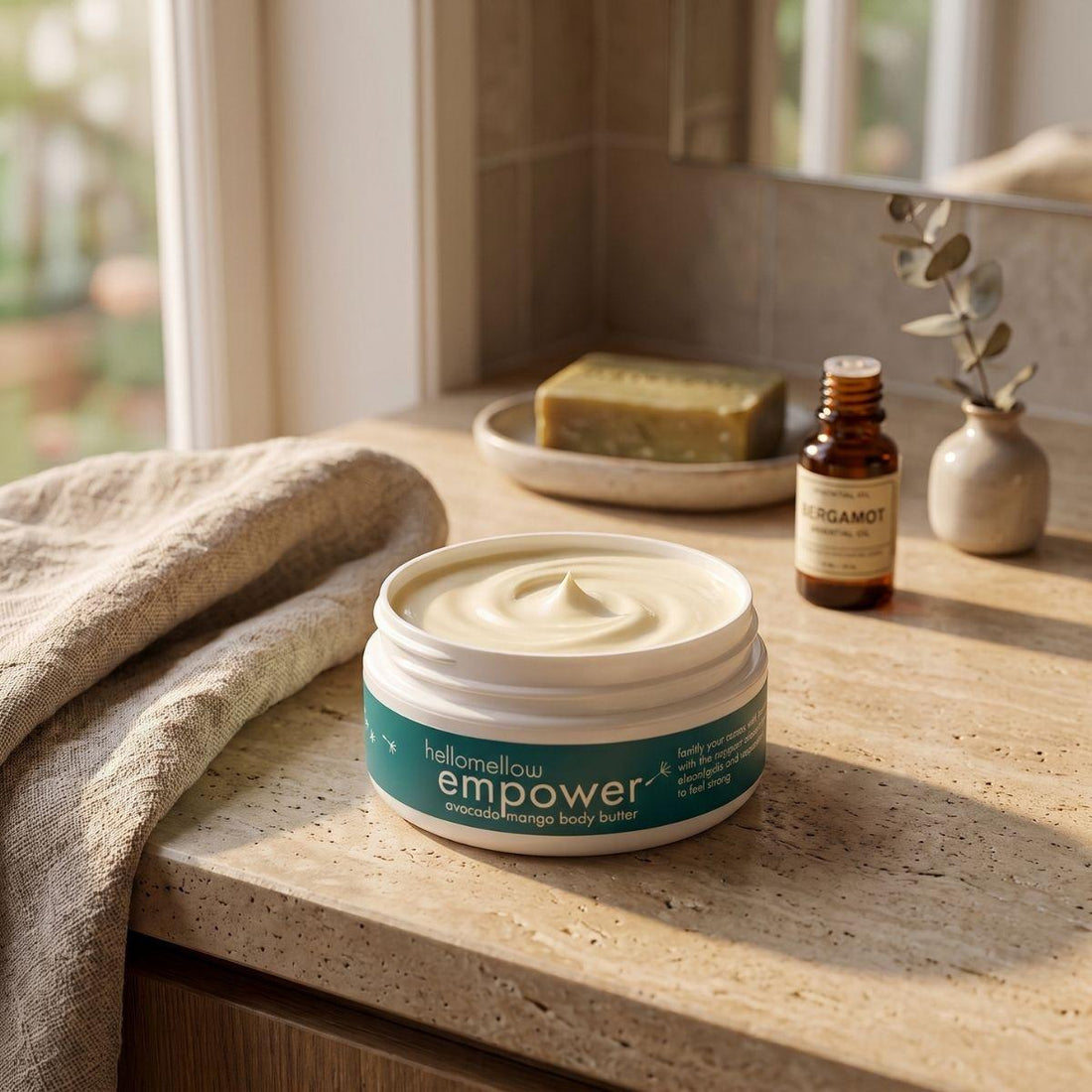 empower body butter on a warm bathroom counter beside a folded towel