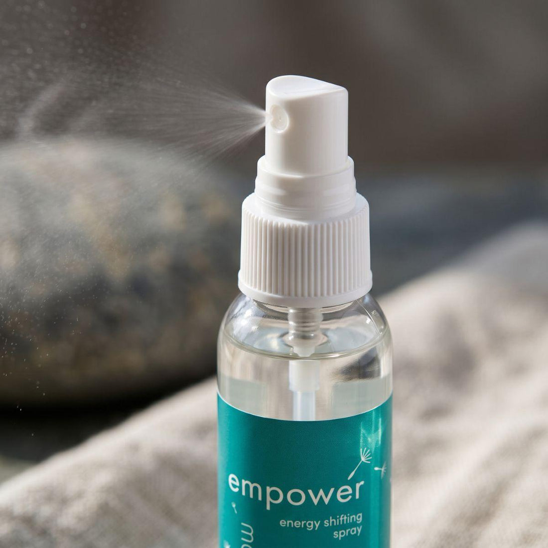 close view of the empower energy shifting spray bottle and its real spray top