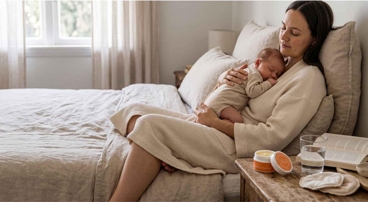 new mother resting with her baby after feeding with preggo boobie butter nearby.
