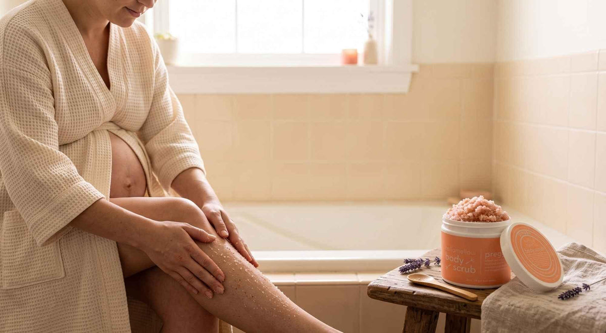 pregnant woman massaging scrub over her lower leg during a quiet bath-side body care ritual.