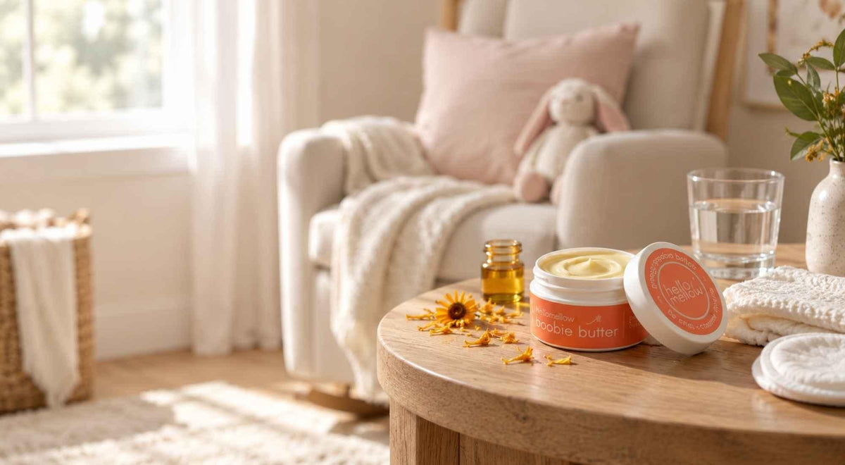 open preggo boobie butter with calendula petals and jojoba oil beside a nursery nursing chair.