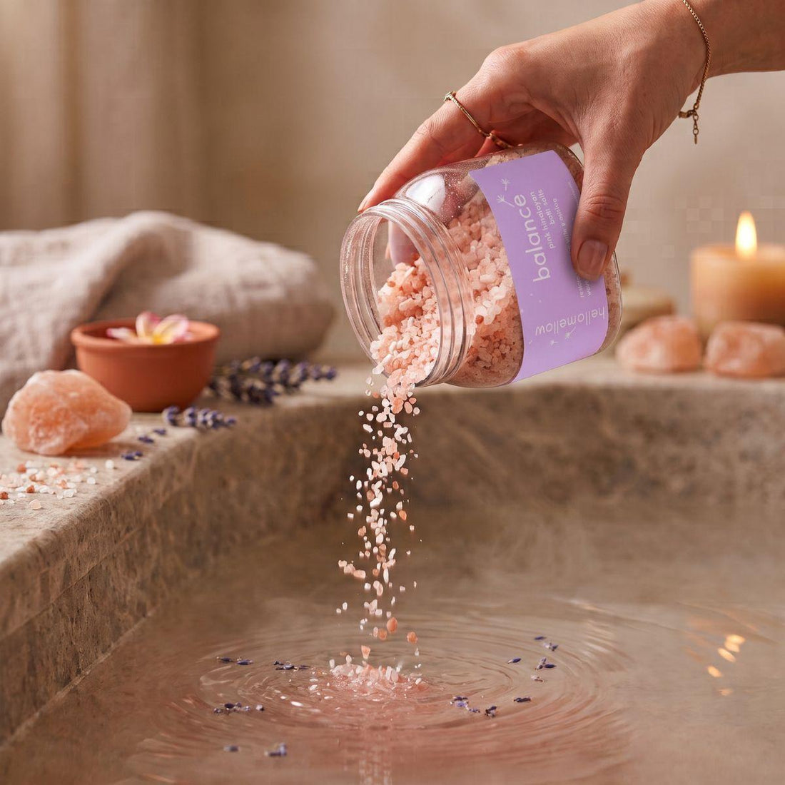balance bath salts being poured in a small amount toward warm bath water
