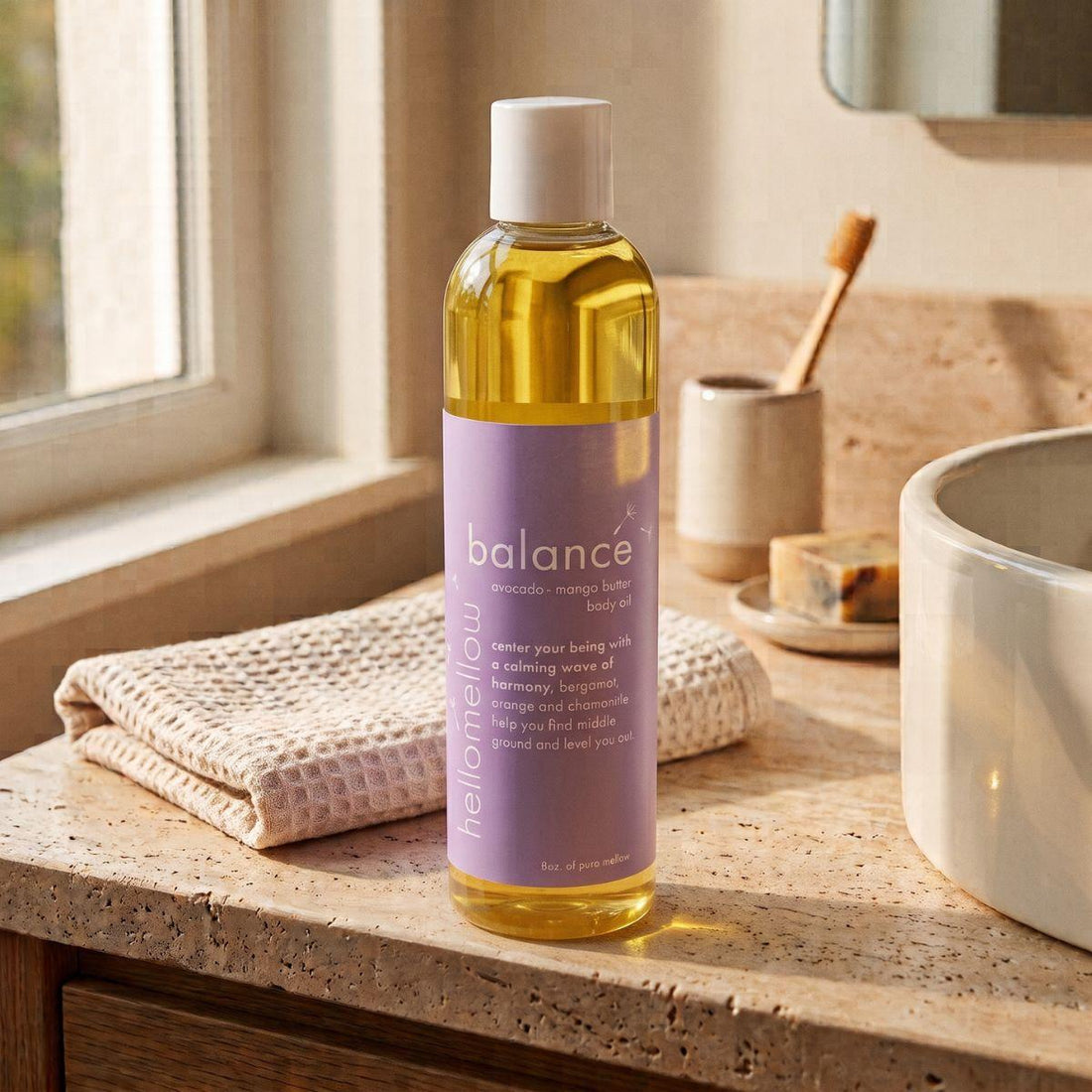 balance body oil on a warm bathroom counter beside a folded towel