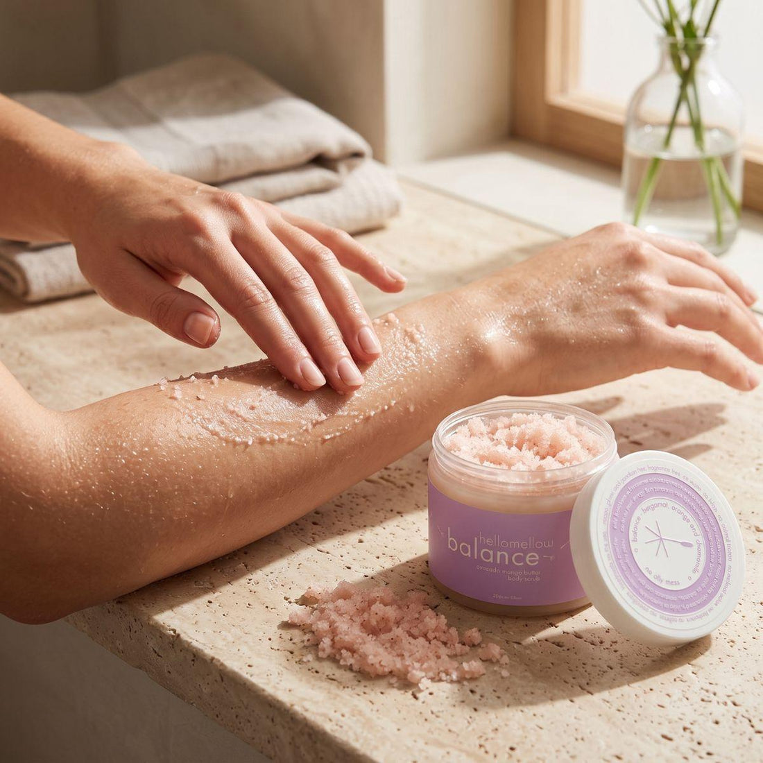 hands massaging balance body scrub onto damp skin in gentle circular motions