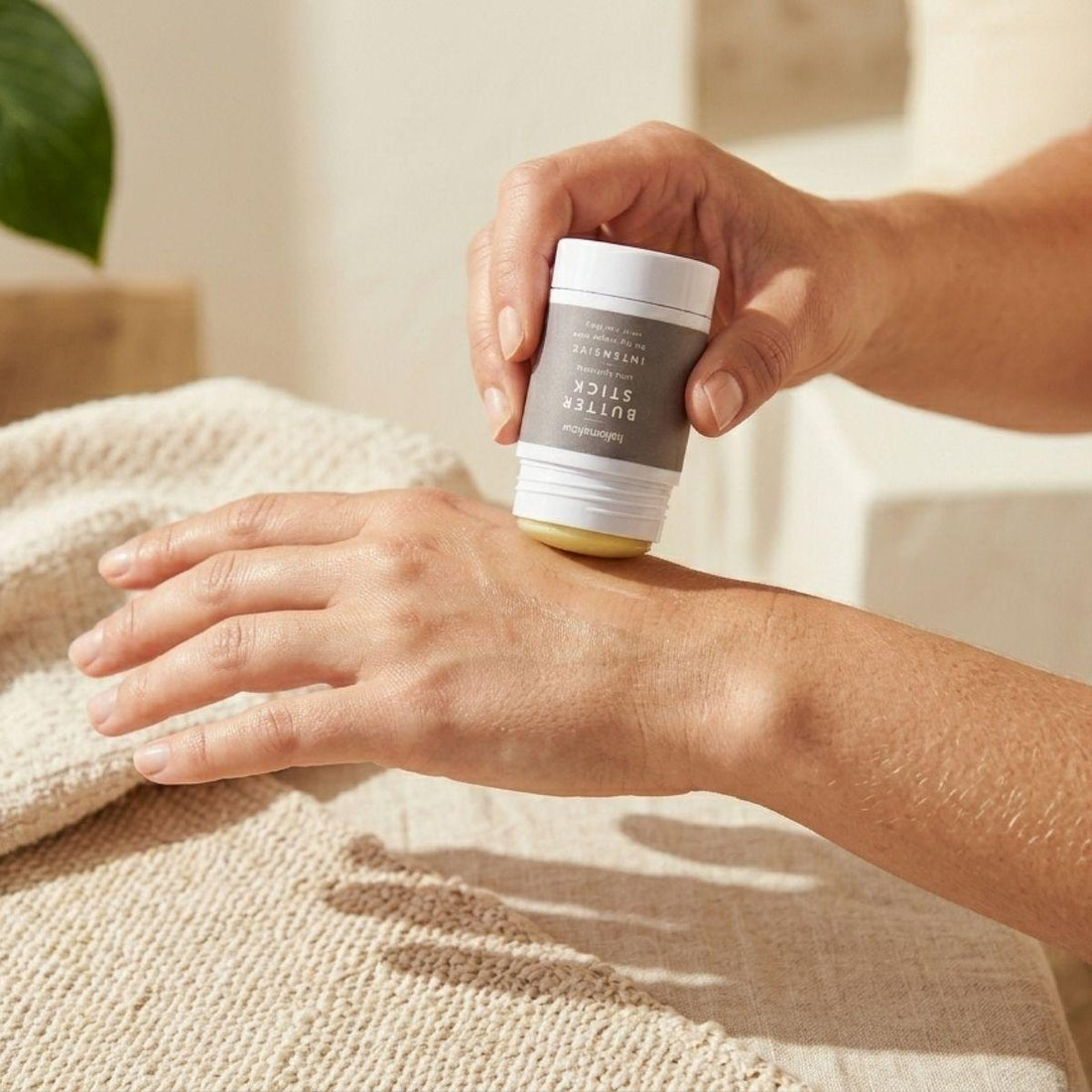 one intensive butter stick being applied by a woman on her hand