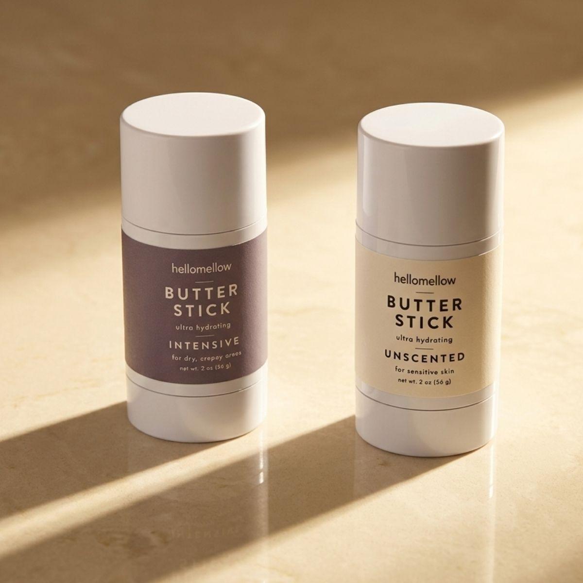 butter stick duo set one intensive butter stick one unscented butter stick on a stone countertop 