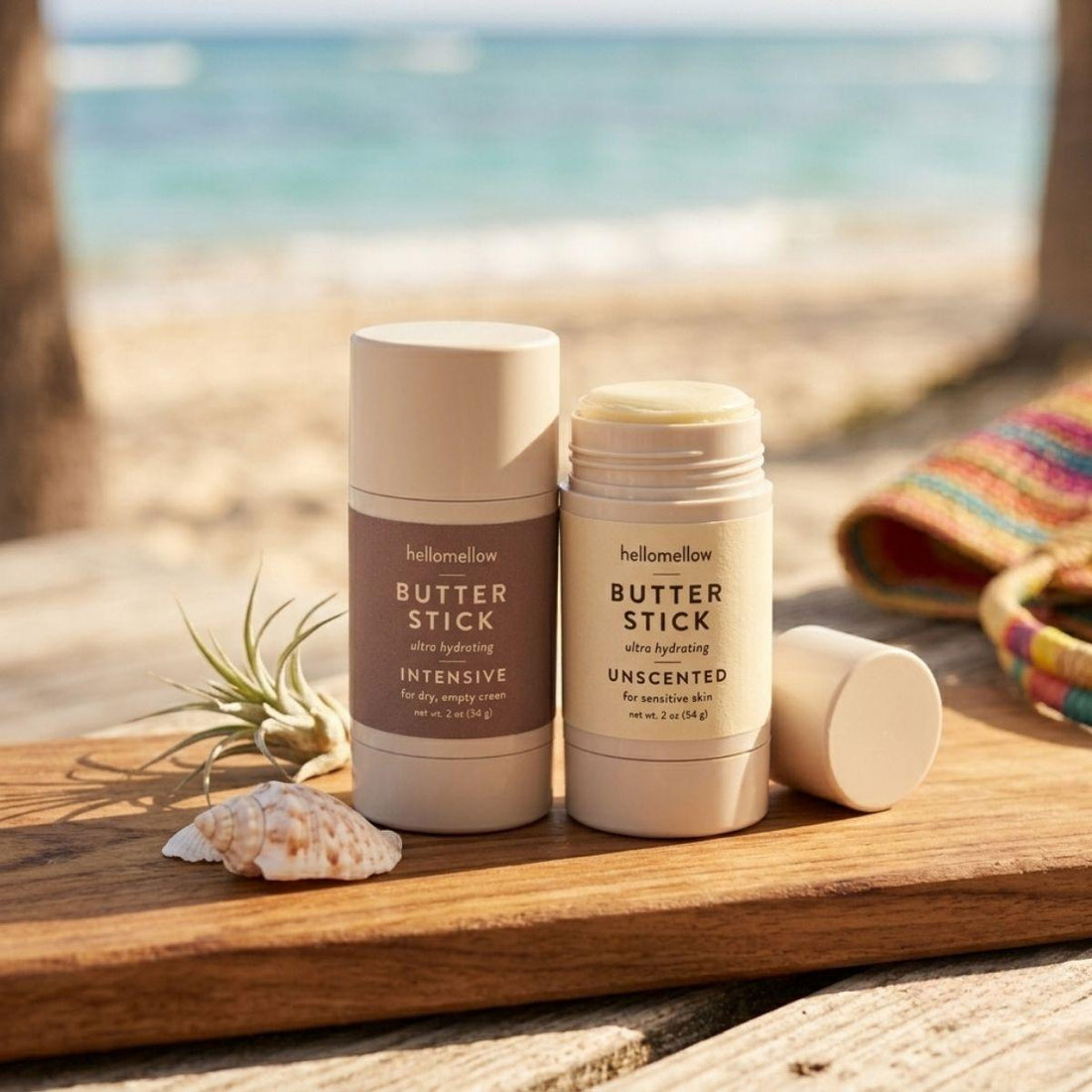 butter stick duo one intensive stick and one unscented stick on a wooden board overlooking a beach