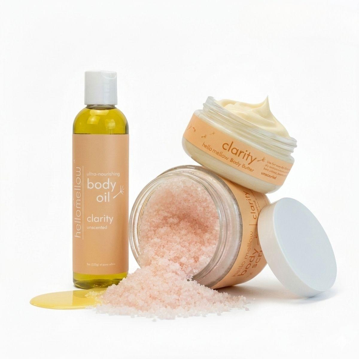 clarity essential routine with tub body butter open butter visible and a body scrub tipped over with the pink himalayan sea salt visible