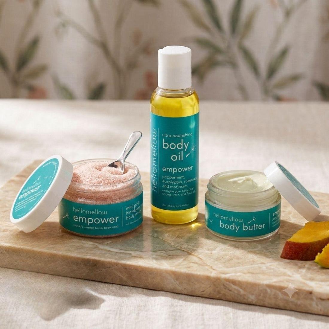 empower mini essential routine in a warm bathroom body butter body oil and boy scrub 