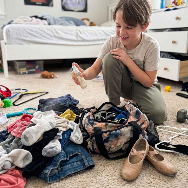 boy spraying hellomellow stink away spray in messy room