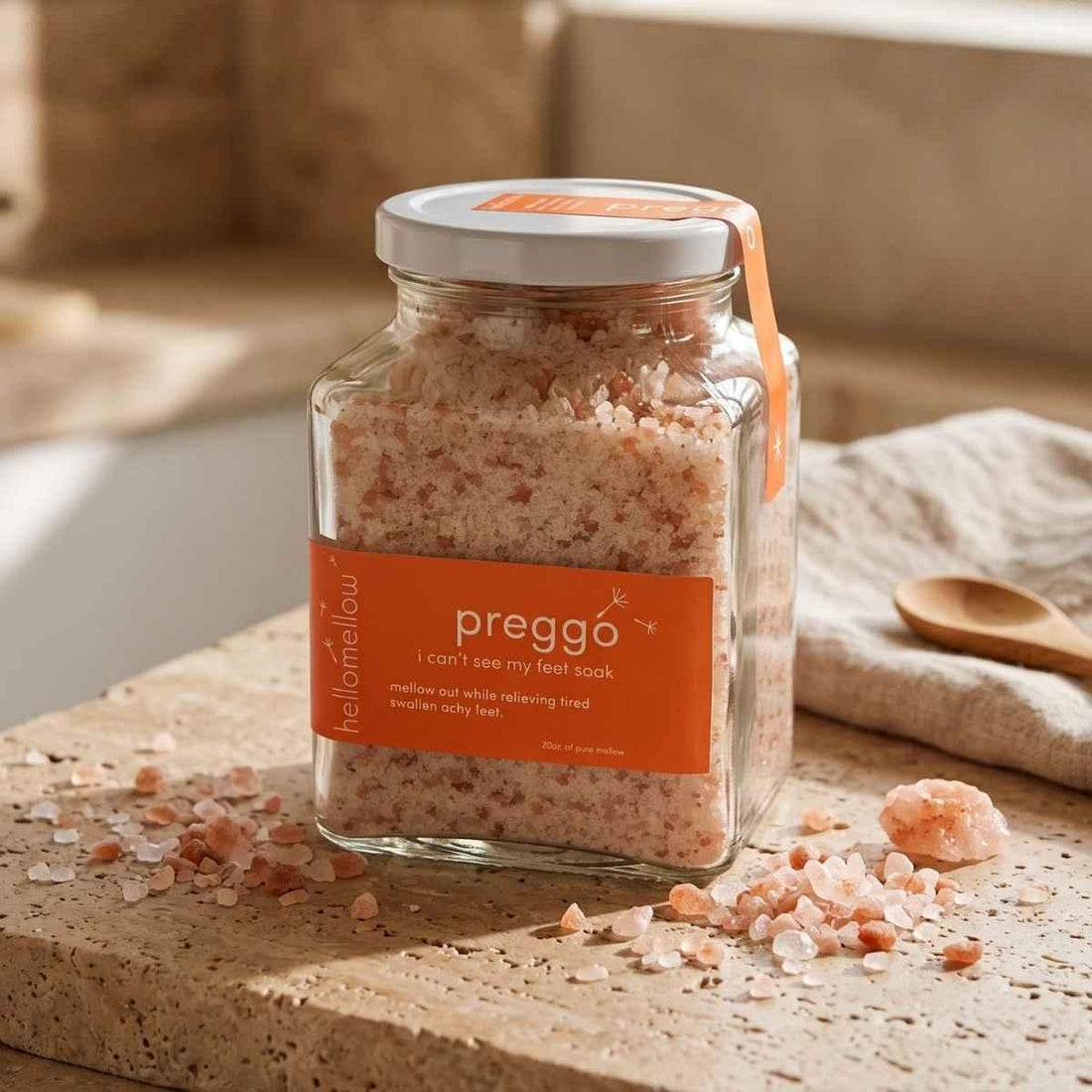 glass jar of i can’t see my feet soak on warm stone beside scattered mineral salts.