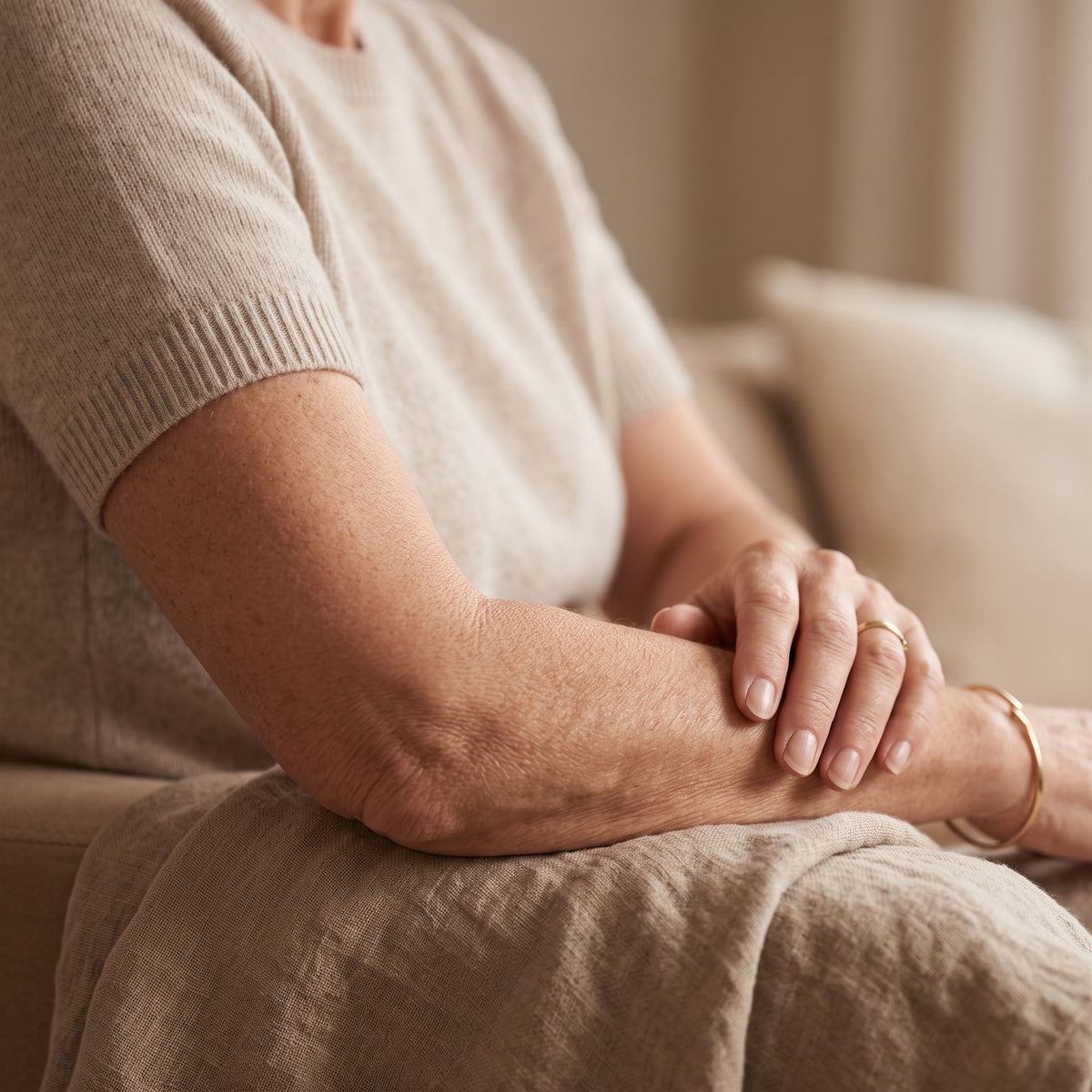 woman in her 50's noticing her skin thinning and looking crepey