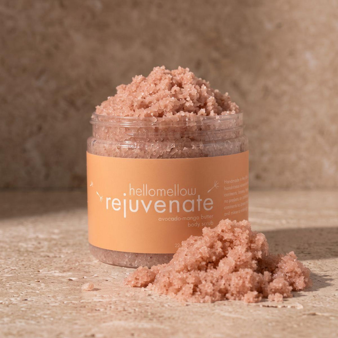 open rejuvenate body scrub showing the natural pink salt texture inside