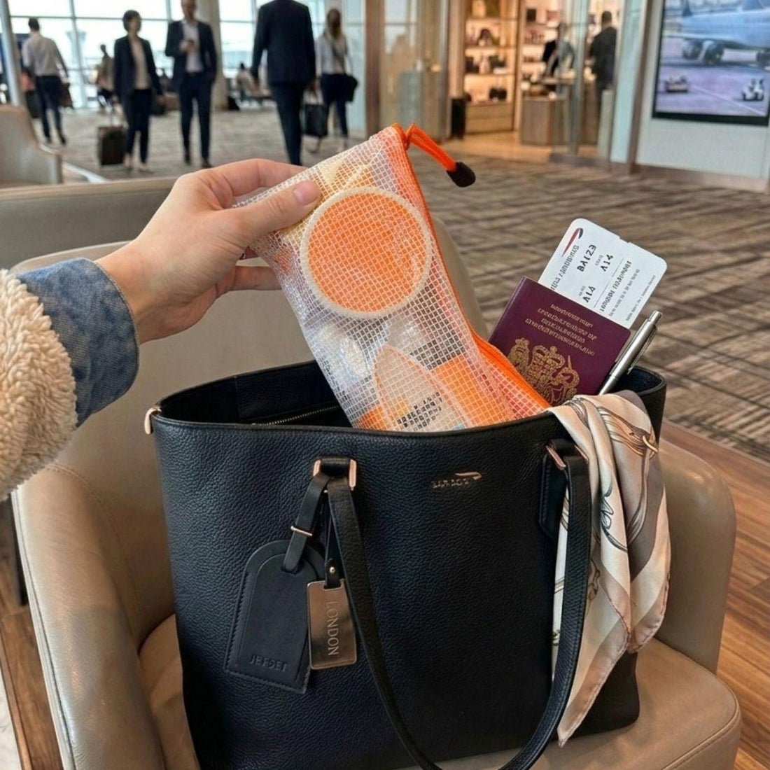 rejuvenate vacay vibe travel bodycare set inside of a purse at the airport 
