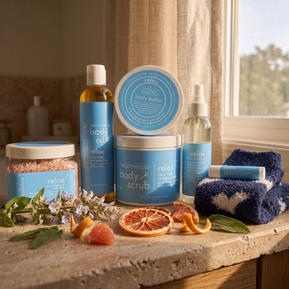 body scrub, body oil, and current butter products grouped together on a warm bathroom counter
