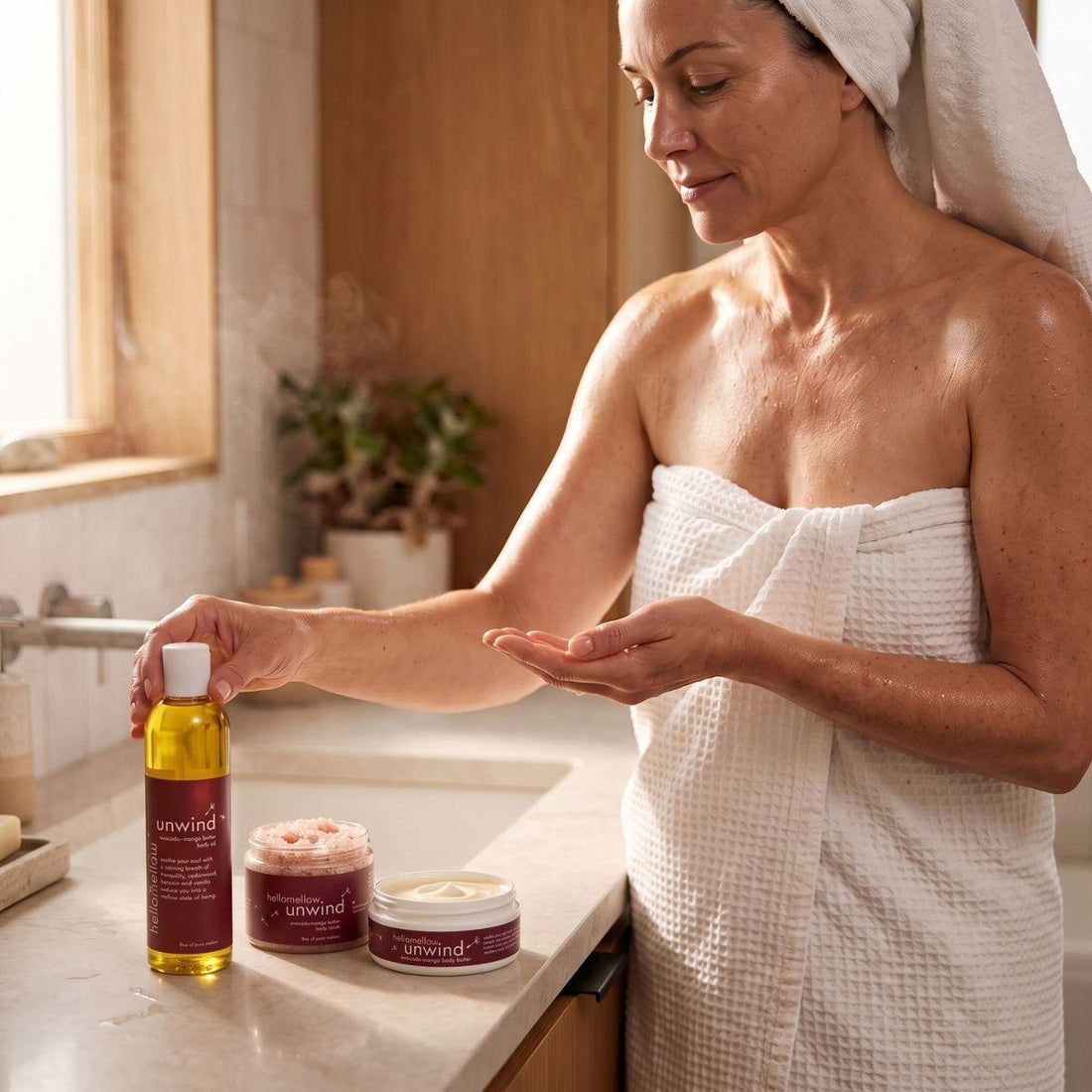 woman touching the top of a unwind body oil 
