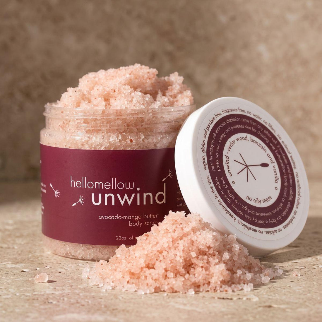 open unwind body scrub showing the natural pink salt texture inside