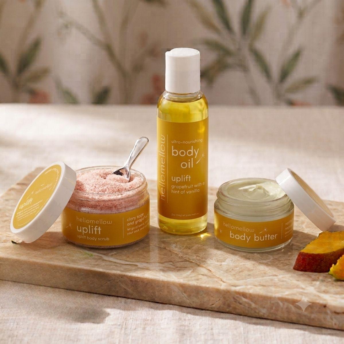 uplift mini essential routine in a warm bathroom body butter body oil and boy scrub 