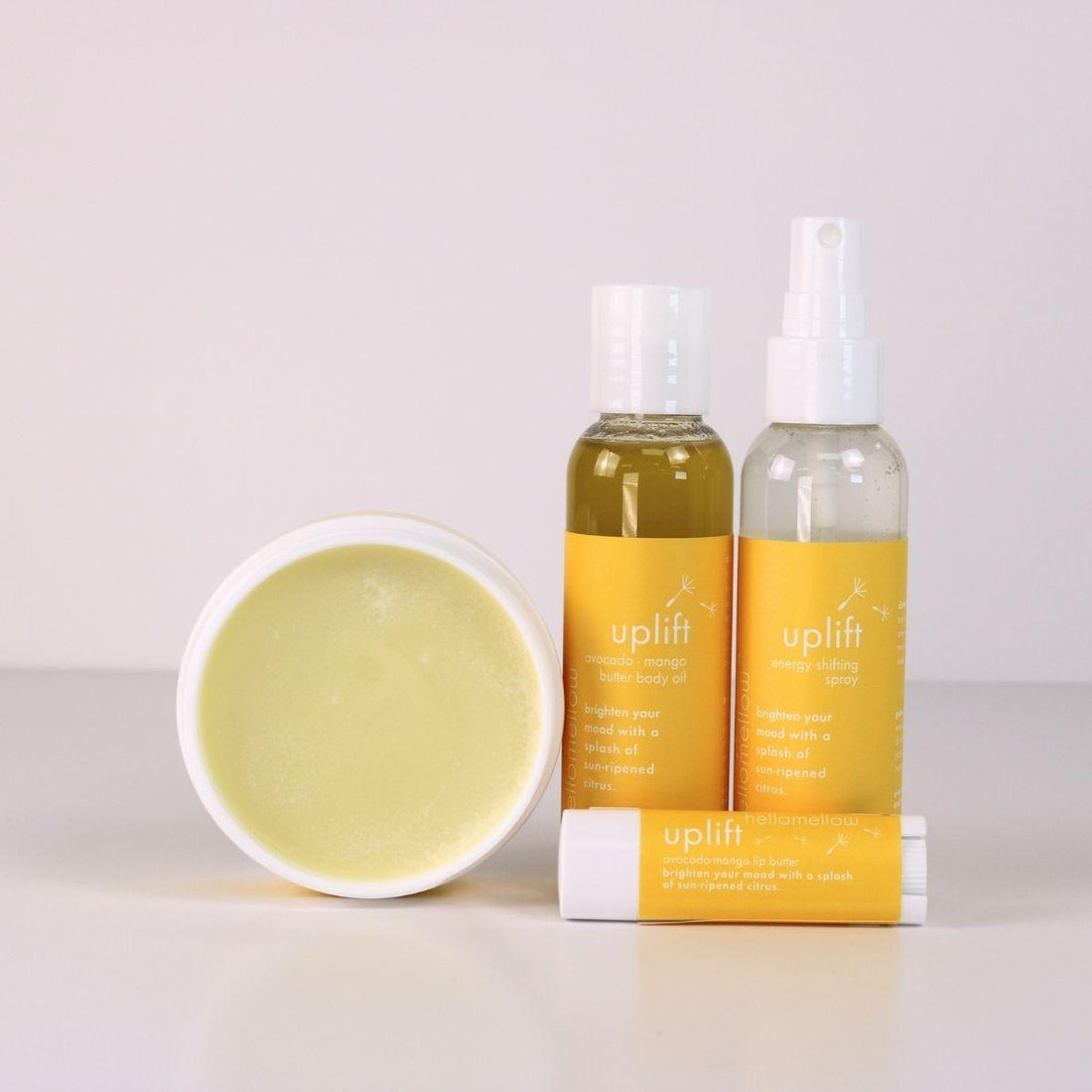 uplift vacay vibe full product lineup with an open body butter, body oil, energy shifting aromatherapy spray, lip butter 